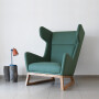 Duży wygodny fotel uszak drewniany skandynawski minimalistyczny butelkowa zieleń