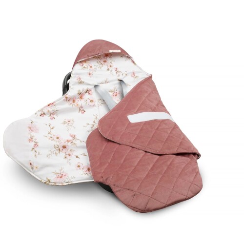 Ciepły otulacz do fotelika samochodowego. W środku w delikatne kwiaty na białym tle, a na zewnątrz różowo-czerwony velvet